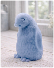 Load image into Gallery viewer, handmade vegan soap in the shape of a realistic young penguin sculpture, featuring a soft downy fur texture and a gentle expression, displayed in a bright farmhouse decor setting.
