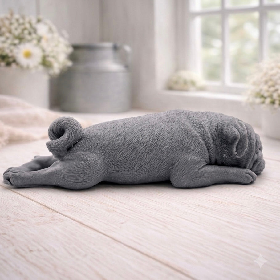 A detailed handmade vegan soap gift, sculpted in the shape of a pug dog lying flat on its stomach in a sleeping position, showing realistic skin folds and fur texture
