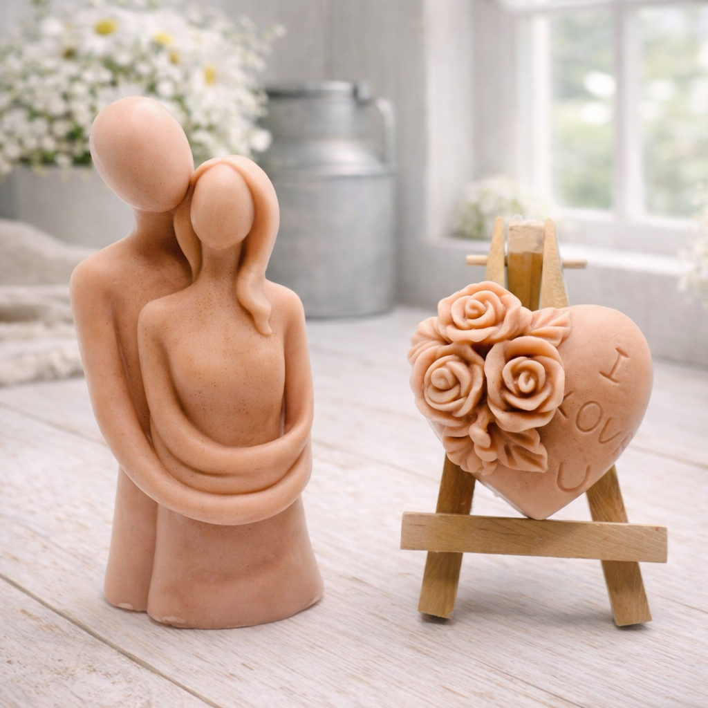 This gift set features a stunning soap sculpture of a man gently embracing a woman alongside a charming rose-adorned heart soap, stamped with the heartfelt message "I LOVE U".