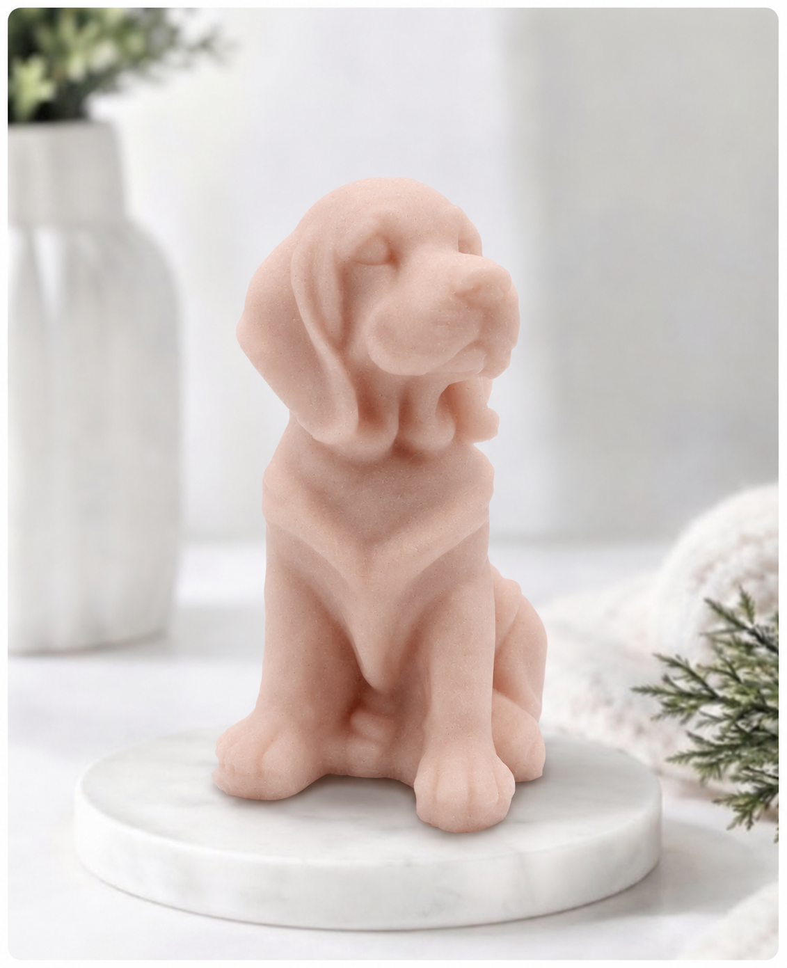 A soft pink Golden Retriever soap sitting on a white marble display stand with a soft bathroom background.