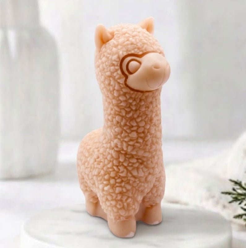 handmade vegan soap in the shape of a realistic standing alpaca sculpture, featuring detailed curly wool texture and a smiling face, displayed on a rustic white wooden surface in a bright farmhouse decor setting.