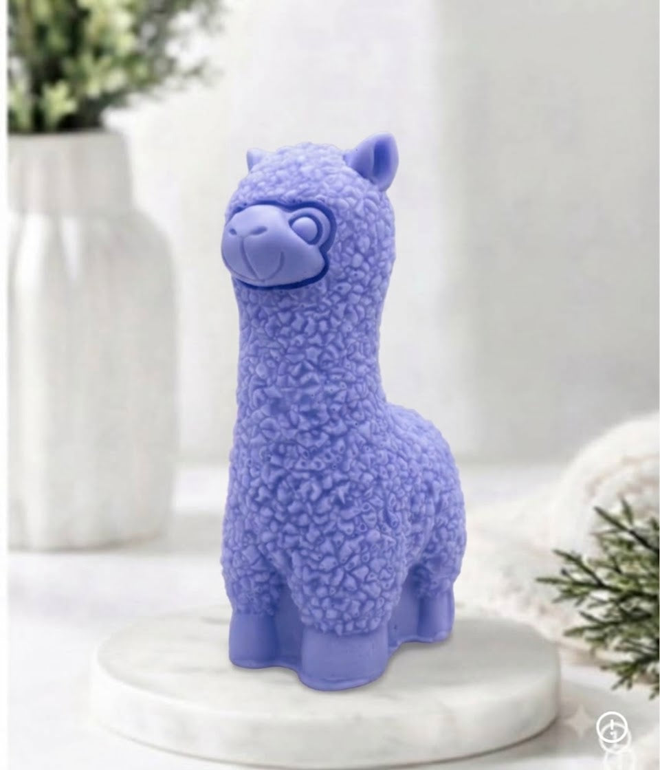 handmade vegan soap in the shape of a realistic standing alpaca sculpture, featuring detailed curly wool texture and a smiling face, displayed on a rustic white wooden surface in a bright farmhouse decor setting.