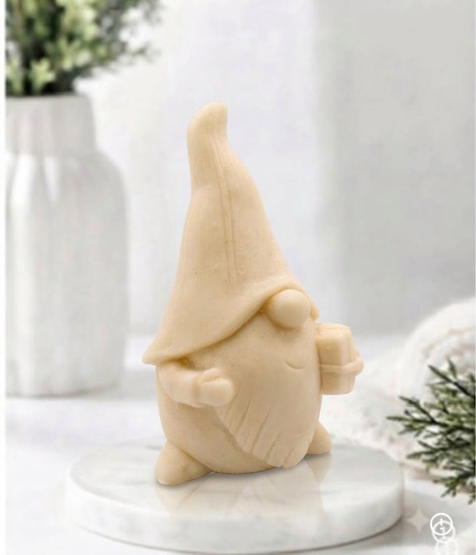 Three-quarter side view of a yellow-coloured gnome soap bar holding a small wrapped gift box