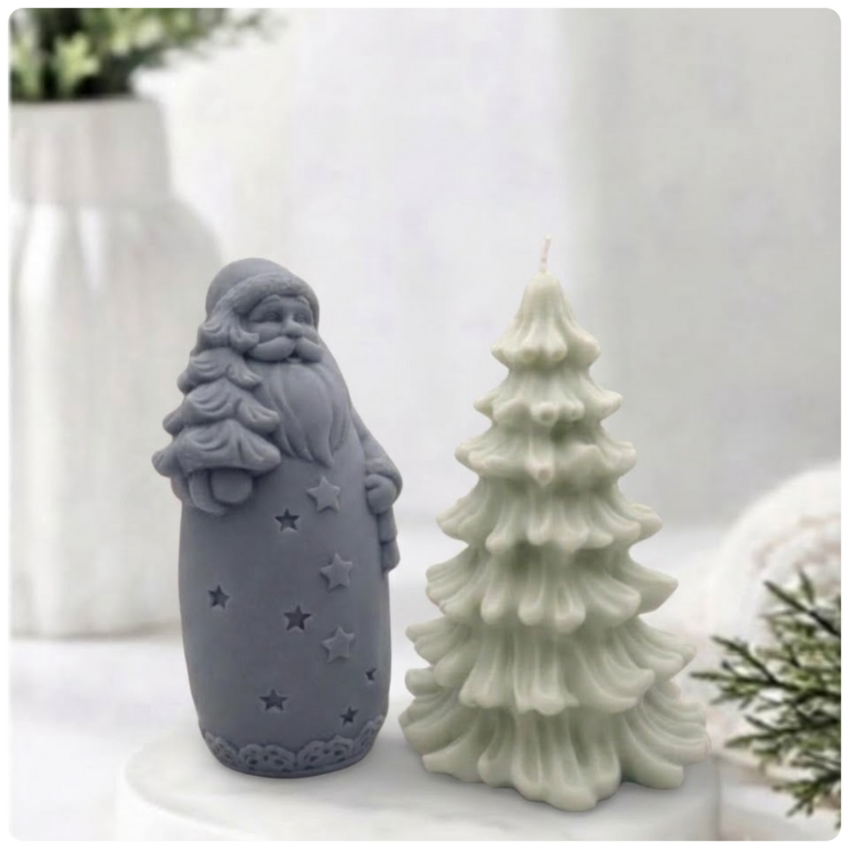 Charcoal grey Santa Claus soap bar displayed beside a light green Christmas tree soap bar.