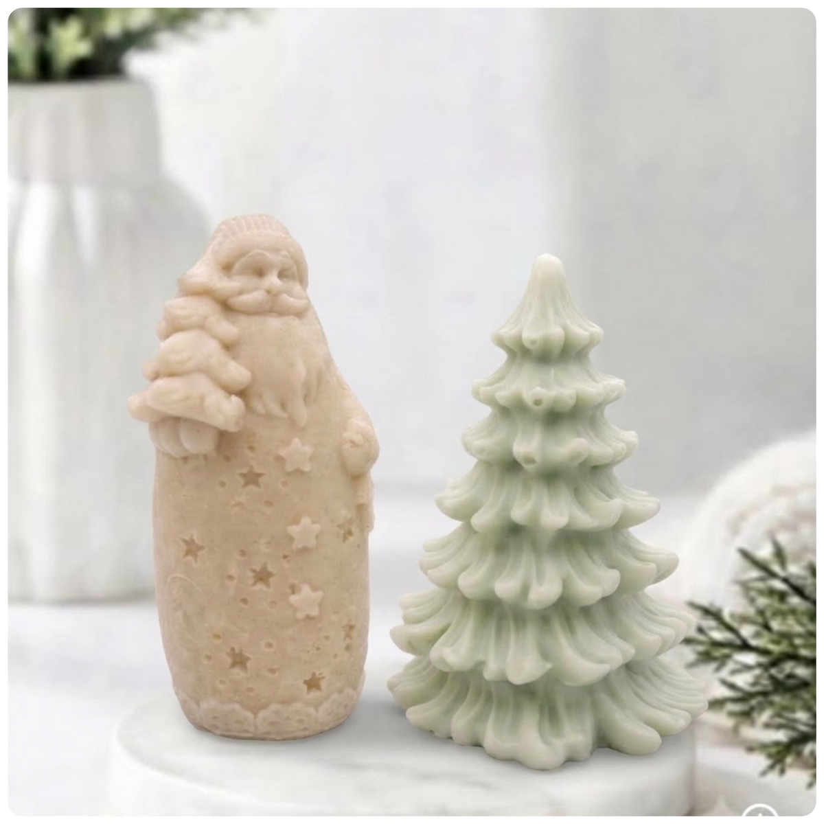 coloured Santa soap bar holding a small tree next to a light green Christmas tree soap bar.