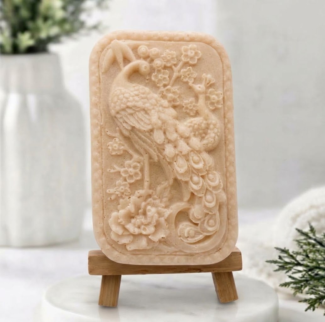 Yellow French clay artisanal peacock vegan soap on a wooden stand against a blurry background. Gift Idea