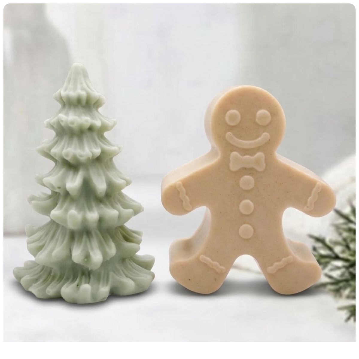 Handmade vegan Christmas tree and gingerbread man soap gift set arranged neatly on a light surface with festive background styling.