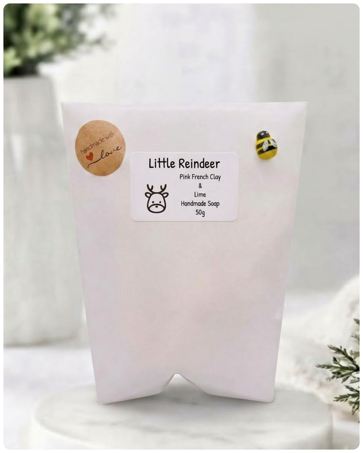 White soap packaging with a label on a light wooden surface