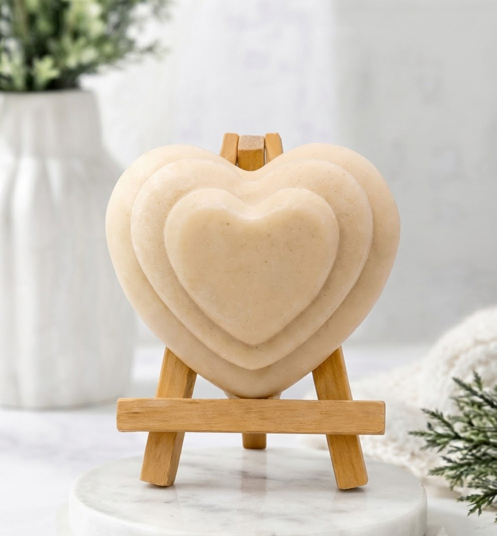 Natural soft yellow vegan heart soap, nested on a wooden easel.