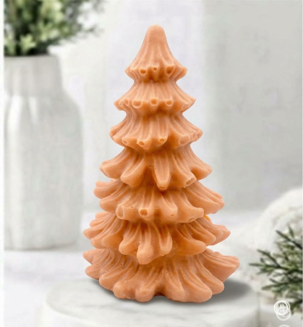 A terracotta vegan soap sculpted into a realistic evergreen Christmas tree with multiple layers of textured, needle-like branches, with a subtle snow-dusted effect.