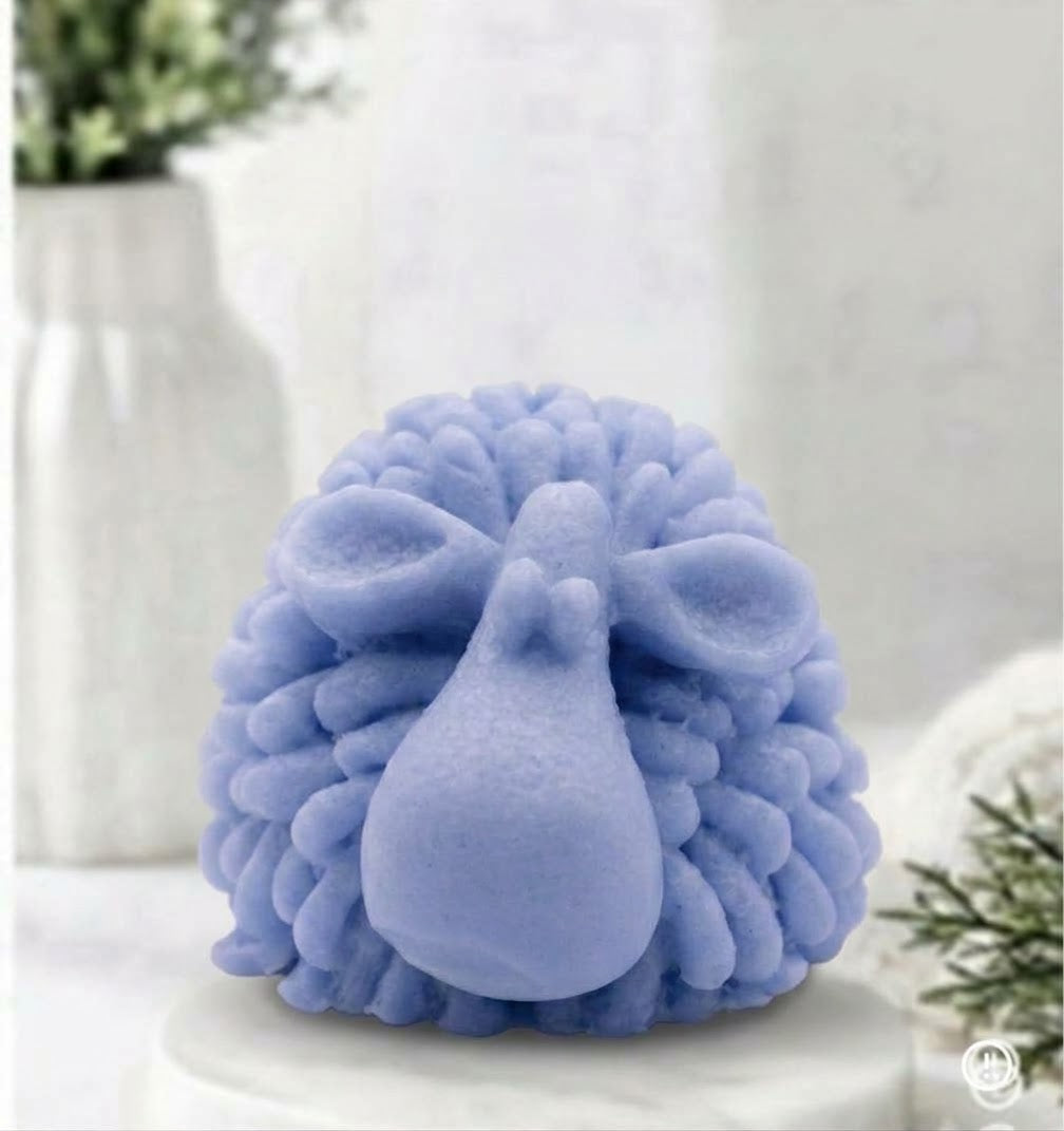 A highly detailed soft blue handmade vegan soap sculpted in the shape of a fluffy sheep with thick, textured wool and a smooth face