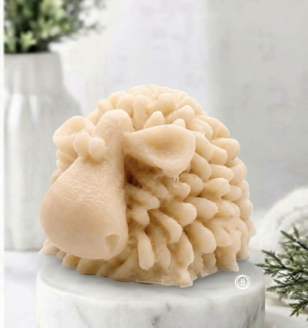 A highly detailed soft yellow handmade vegan soap sculpted in the shape of a fluffy sheep with thick, textured wool and a smooth face