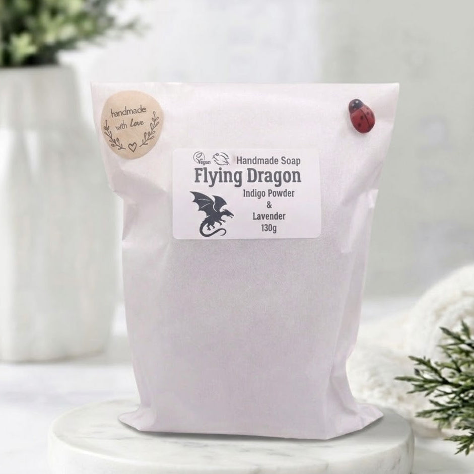 White bag labeled 'Flying Dragon' with a dragon design on a light wooden surface.