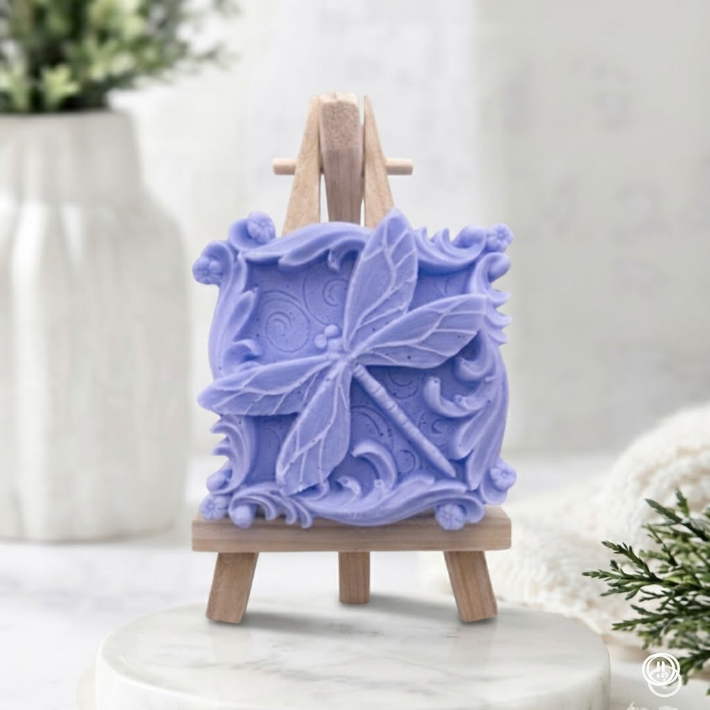 Intricately carved lavender blue vegan soap with raised dragonfly and baroque style filigree.