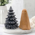 Handmade vegan soap gift set with a grey Christmas tree soap and a terracotta coloured ghost soap arranged on a white marble surface.
