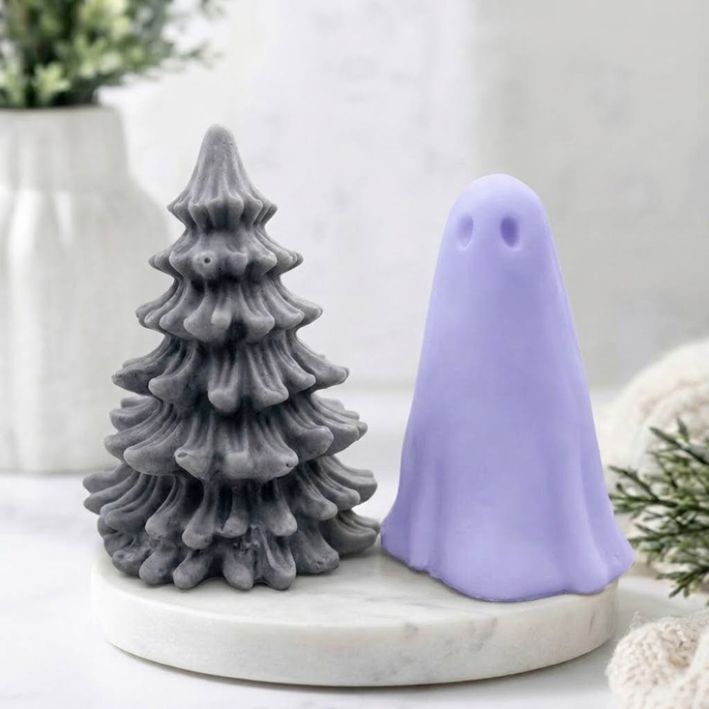 Handmade vegan soap gift set showing a grey Christmas tree soap paired with a pastel blue ghost soap on a white marble base.