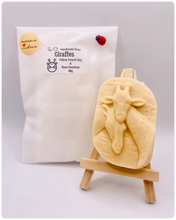 Load image into Gallery viewer, Handmade vegan soaps shaped as two nuzzling giraffes. crafted with natural French clays, activated charcoal and essential oils. a eco-friendly, zero waste gift that’s cruelty-free, skin-nourishing, and perfect for animal lovers and gifting . wrapped in beautiful eco friendly packaging.
