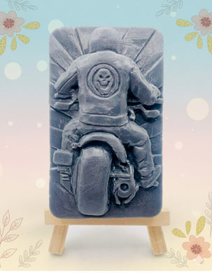 Handmade vegan soaps featuring a biker riding their motorcycle in to the sunset wearing a biker jacket. crafted with natural French clays, activated charcoal and essential oils. a eco-friendly, zero waste gift that’s cruelty-free, skin-nourishing, and perfect for motorbike lovers and gifts for him. Small business UK