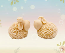 Load image into Gallery viewer, Handmade vegan soap featuring a set of two spring lambs and gift boxed in beautiful eco friendly packaging. crafted with natural French clays, activated charcoal and essential oils. a eco-friendly, zero waste gift that’s cruelty-free, skin-nourishing, and perfect for easter, sheep lovers or animal themed gifts. Small business UK
