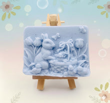 Load image into Gallery viewer, Handmade vegan soaps featuring the easter bunny with a basket full of chicks. , in beautiful eco friendly packaging. crafted with natural French clays, activated charcoal and essential oils. a eco-friendly, zero waste gift that’s cruelty-free, skin-nourishing, the perfect gift for easter and animal lovers. small business UK
