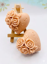 Load image into Gallery viewer, Handmade vegan soaps featuring a set of two love heart soaps with wording I LOVE U with flowers, gift boxed in beautiful eco friendly packaging. crafted with natural French clays, activated charcoal and essential oils. a eco-friendly, zero waste gift that’s cruelty-free, skin-nourishing, and perfect for romantic valentines gifts and anniversary gifts. small business UK
