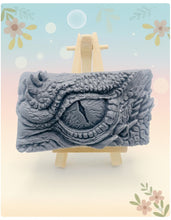 Load image into Gallery viewer, dragon Gift | dragon eye gift, dino gift, alternative gift, Dragon / Dinosaur Eye Vegan Soap Wooden display easels are available to purchase on a separate listing  Calling all fantasy lovers! Step into a realm of mystical charm with our captivating dragon / dinosaur eye soap. This soap is vegan, cruelty free and available in your choice of colour and essential oil. All our soaps are made with natural clays and essential oils to gently cleanse and nourish your skin. eco conscious gift
