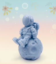 Load image into Gallery viewer, Handmade vegan soaps featuring a detailed astronaut / spaceman sitting  on the moon. crafted with natural French clays, activated charcoal and essential oils. a eco-friendly, zero waste gift that’s cruelty-free, skin-nourishing, and perfect for space lover gifts. gifts for him. Wrapped in beautiful eco friendly packaging. Small Business UK
