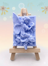 Load image into Gallery viewer, Handmade vegan soaps featuring a fairy sitting on leaves and holding a flower in beautiful eco friendly packaging. crafted with natural French clays, activated charcoal and essential oils. a eco-friendly, zero waste gift that’s cruelty-free, skin-nourishing, the perfect gift for fairy lovers or mothers day. small business UK
