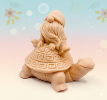 Load image into Gallery viewer, Handmade vegan soaps featuring a detailed turtle with a gnome catching a ride on his back soap. crafted with natural French clays, activated charcoal and essential oils. a eco-friendly, zero waste gift that’s cruelty-free, skin-nourishing, and perfect for turtle lovers and gnome lover gifts. small business UK
