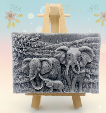 Handmade vegan soap featuring an elephant family with baby elephant and packed in beautiful eco friendly packaging. crafted with natural French clays, activated charcoal and essential oils. a eco-friendly, zero waste gift that’s cruelty-free, skin-nourishing, and perfect for elephant lovers or animal themed gifts. Small business UK