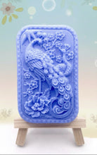 Load image into Gallery viewer, Handmade vegan soaps featuring a detailed peacock, in beautiful eco friendly packaging. crafted with natural French clays, activated charcoal and essential oils. a eco-friendly, zero waste gift that’s cruelty-free, skin-nourishing, the perfect gift for peacock lovers or for animal lovers. small business UK

