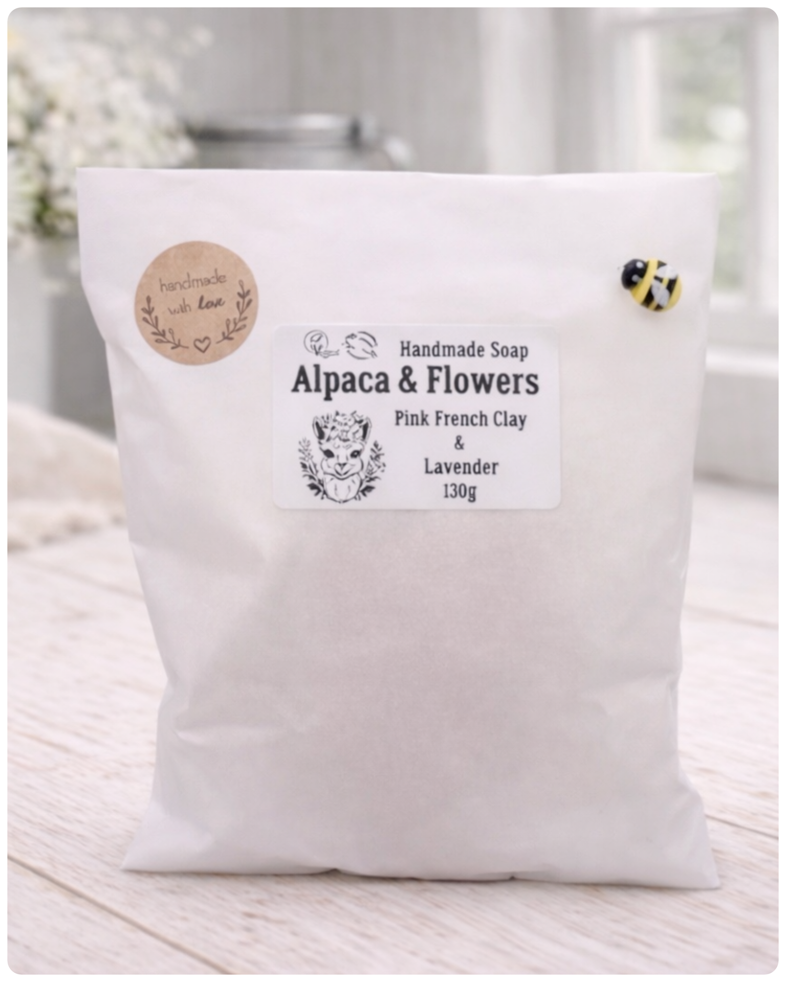 Handmade soap package labeled 'Alpaca & Flowers' on a white surface.