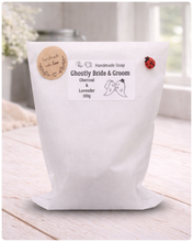 Load image into Gallery viewer, Handmade soap package labeled 'Ghostly Bride &amp; Groom' on a wooden surface.
