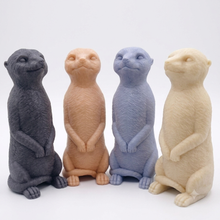 Load image into Gallery viewer, A highly detailed handmade vegan soap, sculpted in the shape of a realistic meerkat standing upright in its iconic sentinel pose, featuring textured fur and a curious facial expression, displayed on a light wooden surface.
