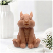 Load image into Gallery viewer, Handmade 3D squirrel-shaped soap sitting upright on a white marble display stand, featuring detailed textured fur and a bushy tail.
