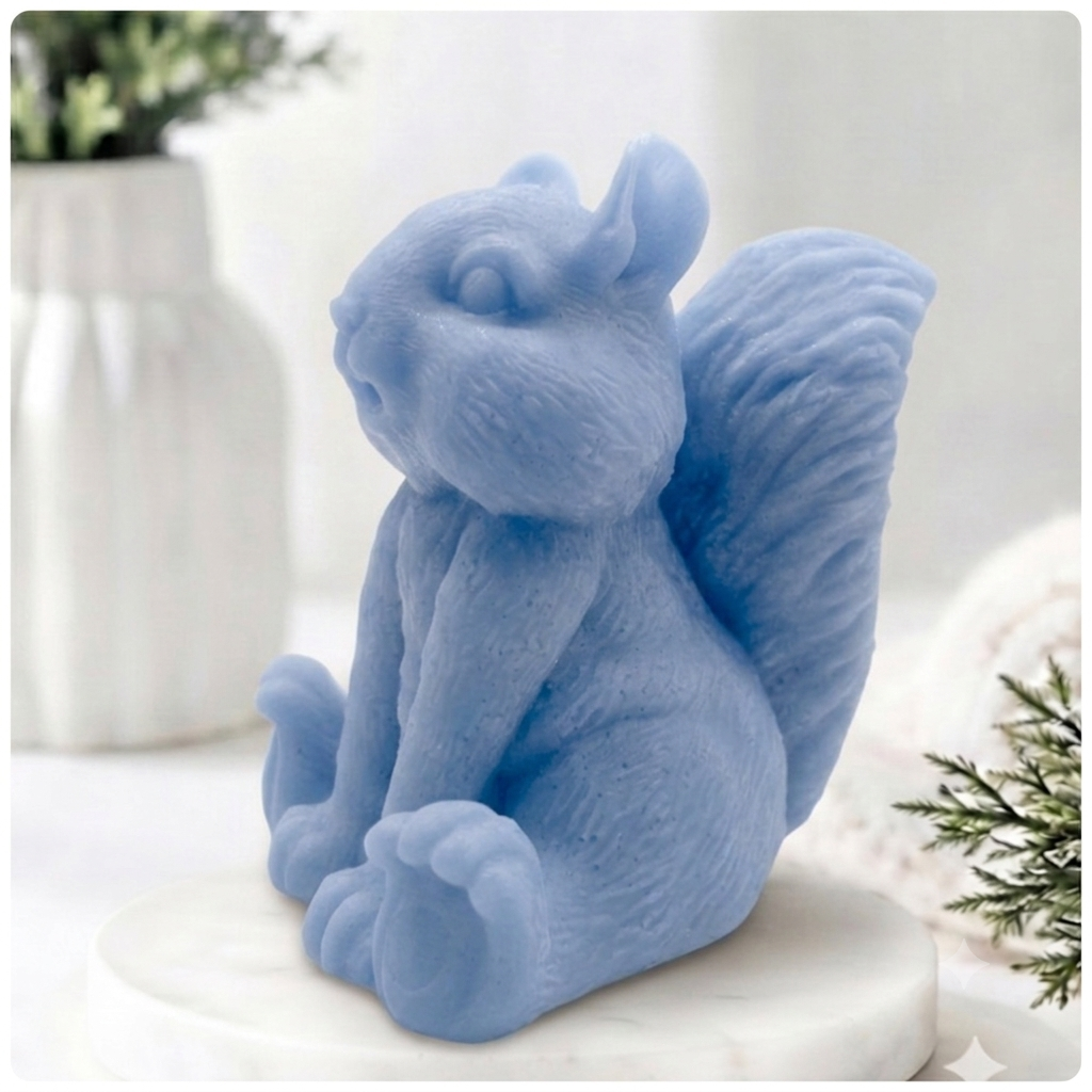 Handmade 3D squirrel-shaped soap sitting upright on a white marble display stand, featuring detailed textured fur and a bushy tail.