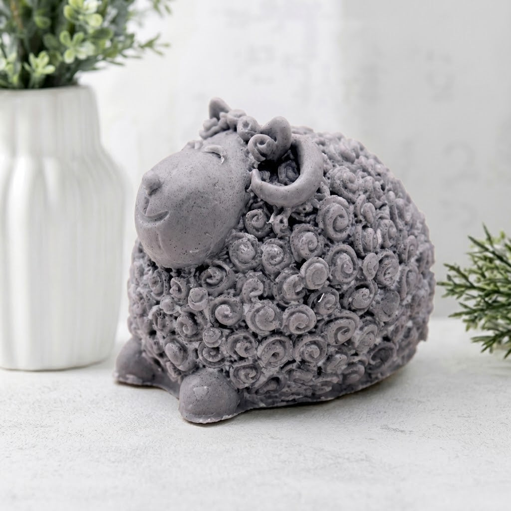 Handmade grey vegan sheep soap sitting proudly with detailed curly wool texture and a smiling face.