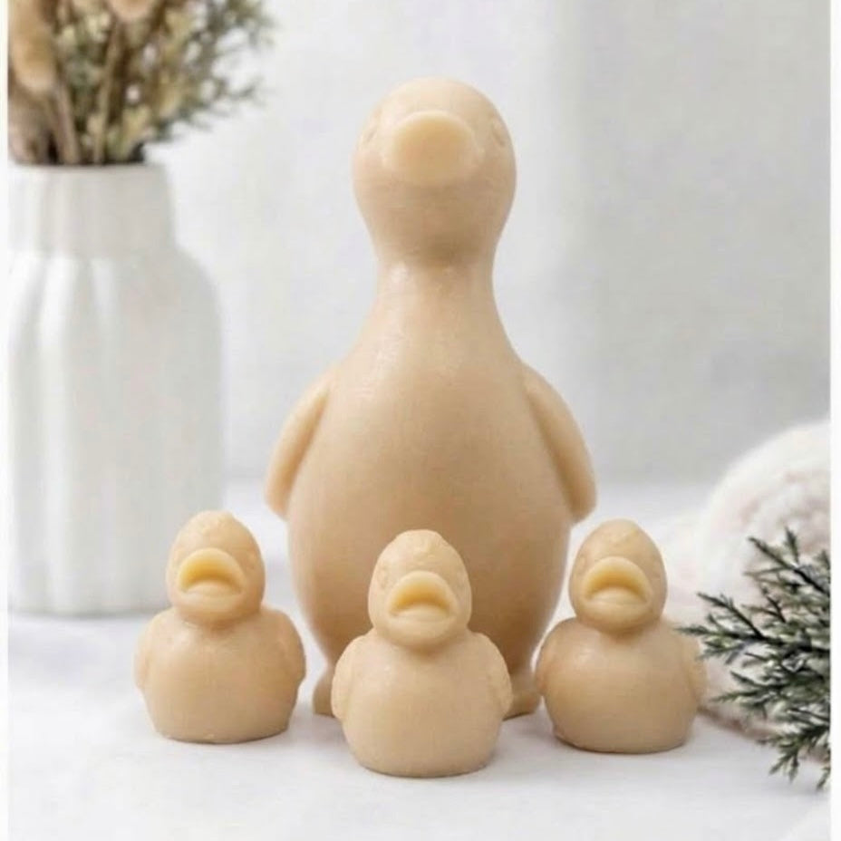 Natural plant-based duck and ducklings vegan soap gift set in a soft yellow colour, arranged in a row with a decorative vase and foliage.