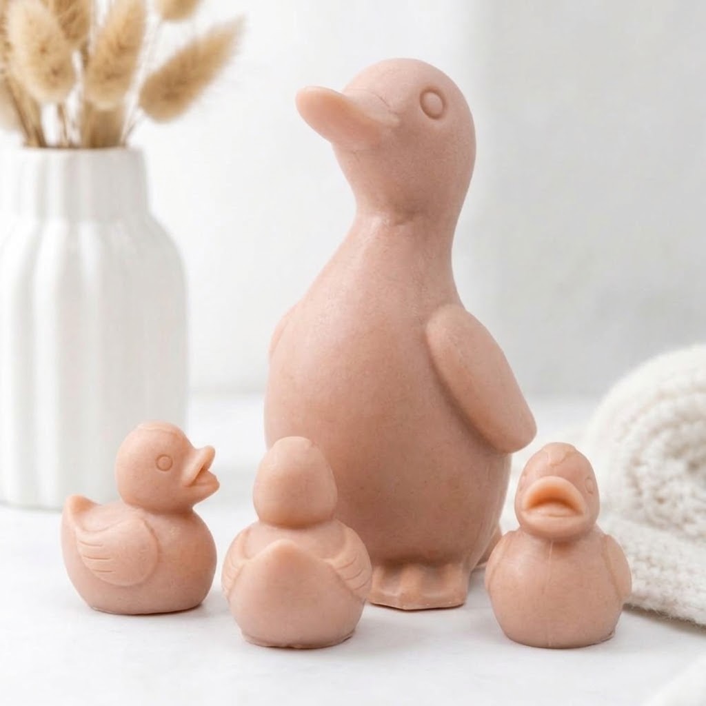 Handmade vegan soap gift set featuring a large duck soap and three little ducklings in a soft pink clay tone.
