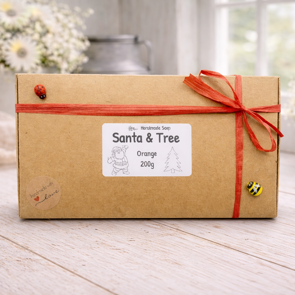 Kraft paper box with orange ribbon and 'Santa & Tree' label on a wooden surface.