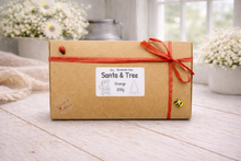 Load image into Gallery viewer, Kraft paper box with orange ribbon and 'Santa &amp; Tree' label on a wooden surface.
