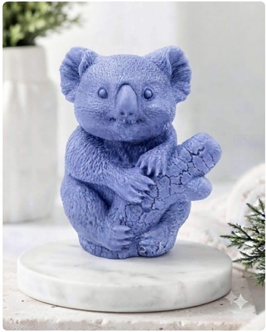A highly detailed handmade vegan soap in a sculpted in the shape of a realistic koala bear sitting upright and clutching a textured eucalyptus branch, displayed on a light wooden surface in a bright farmhouse background 