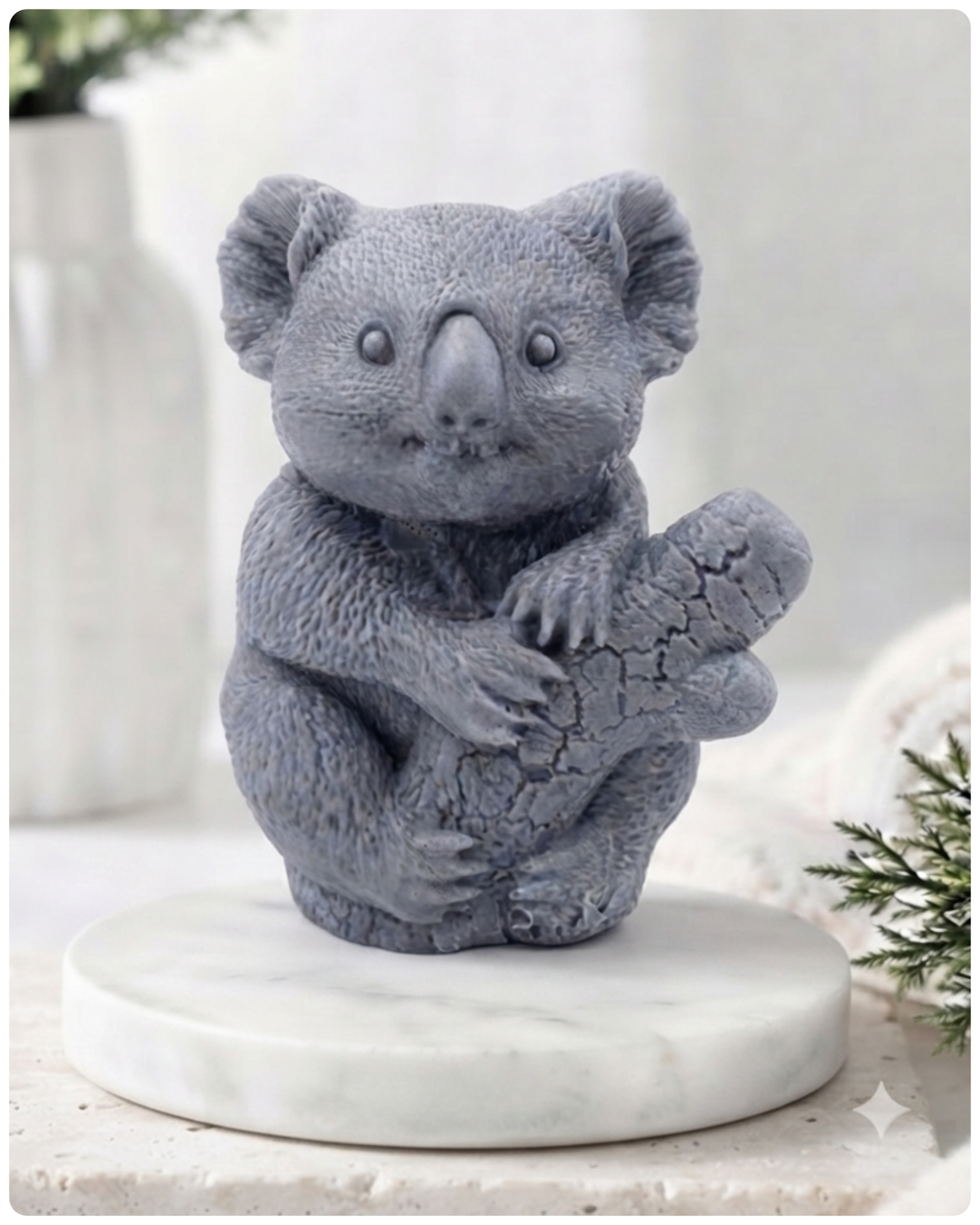 A highly detailed handmade vegan soap in a sculpted in the shape of a realistic koala bear sitting upright and clutching a textured eucalyptus branch, displayed on a light wooden surface in a bright farmhouse background 