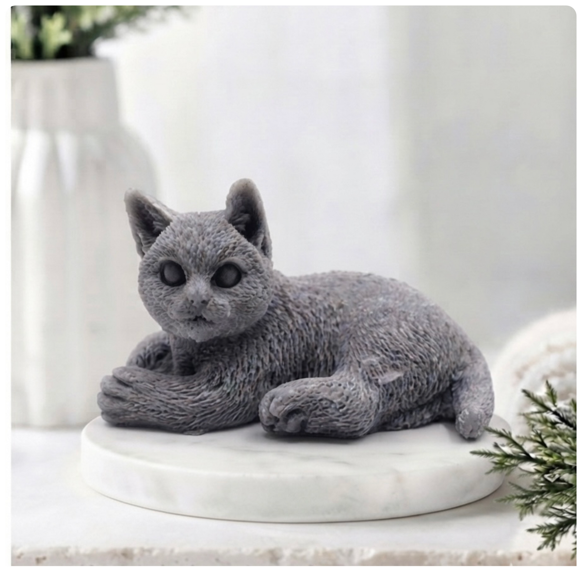 A highly detailed handmade vegan soap sculpted in the shape of a sitting cat with its tail curled around its paws, featuring realistic fur texture and a sweet facial expression, displayed on a light wooden surface.