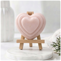 handmade vegan soap gift featuring a triple-tiered heart relief design, displayed on a wooden easel against a rustic farmhouse decor background with lavender.