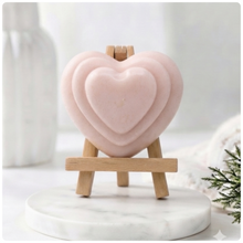 Load image into Gallery viewer, handmade vegan soap gift featuring a triple-tiered heart relief design, displayed on a wooden easel against a rustic farmhouse decor background with lavender.
