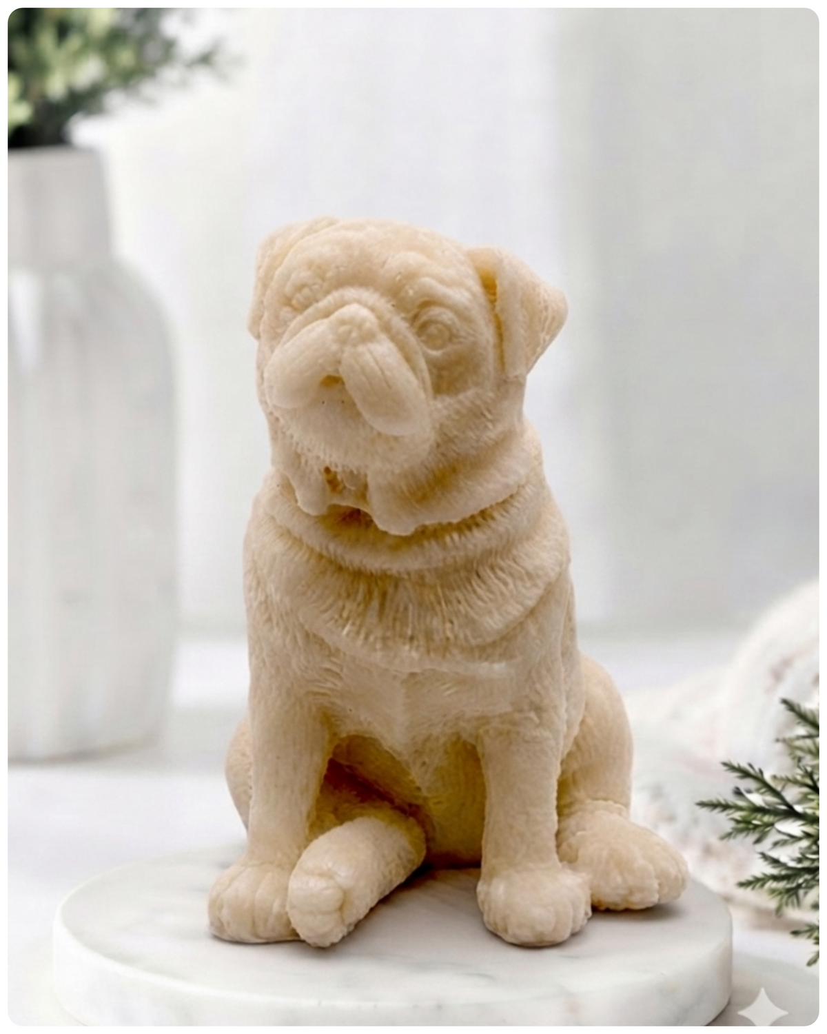 A detailed handmade vegan soap sculpted in the shape of a sitting pug dog with characteristic facial wrinkles and a tilted head, in a natural tone, displayed on a light wooden surface.