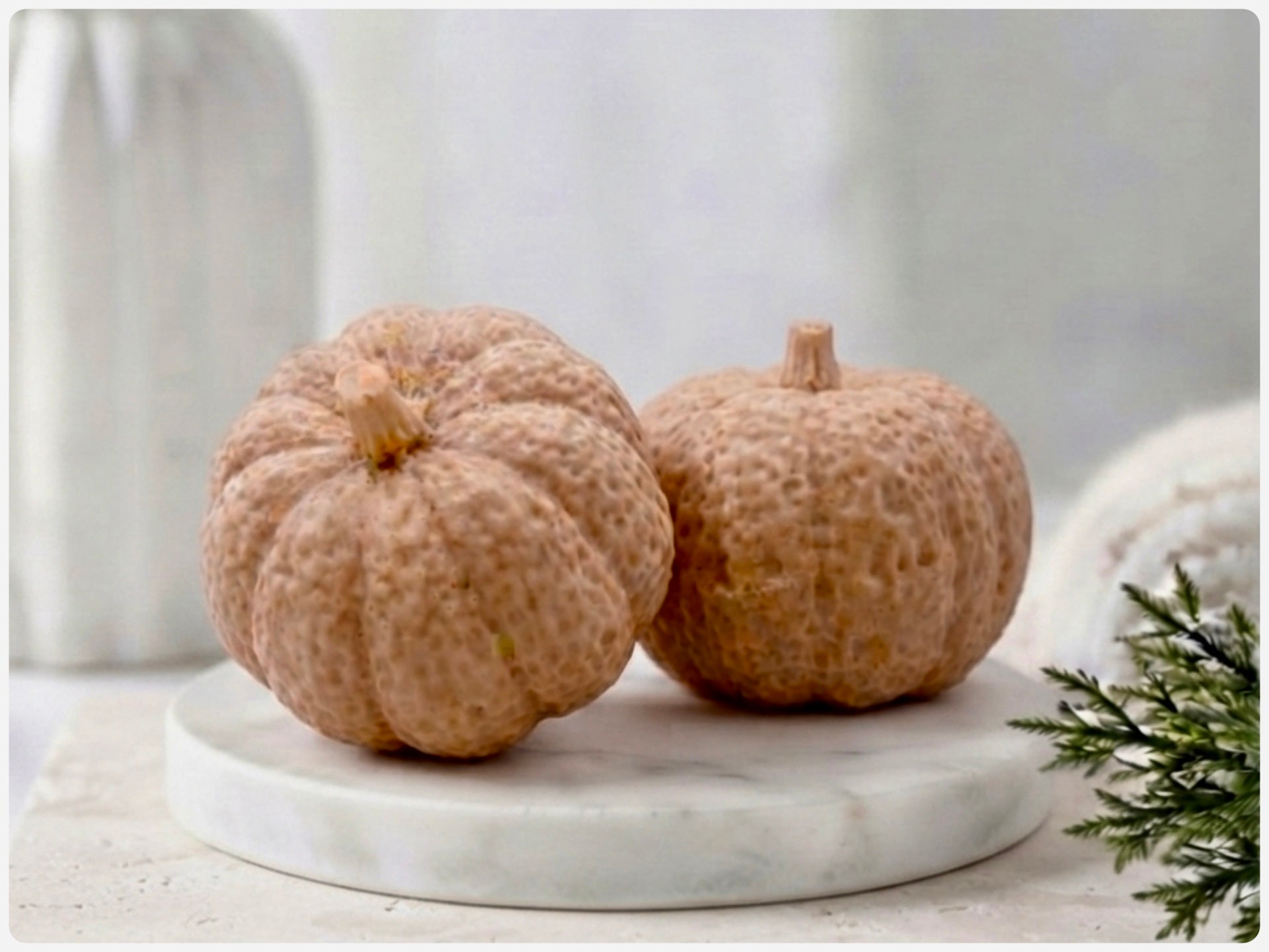 handmade vegan soaps in the shape of realistic chunky pumpkins, featuring detailed bumpy skin texture and stems, displayed on a rustic white wooden surface in a bright farmhouse decor setting.