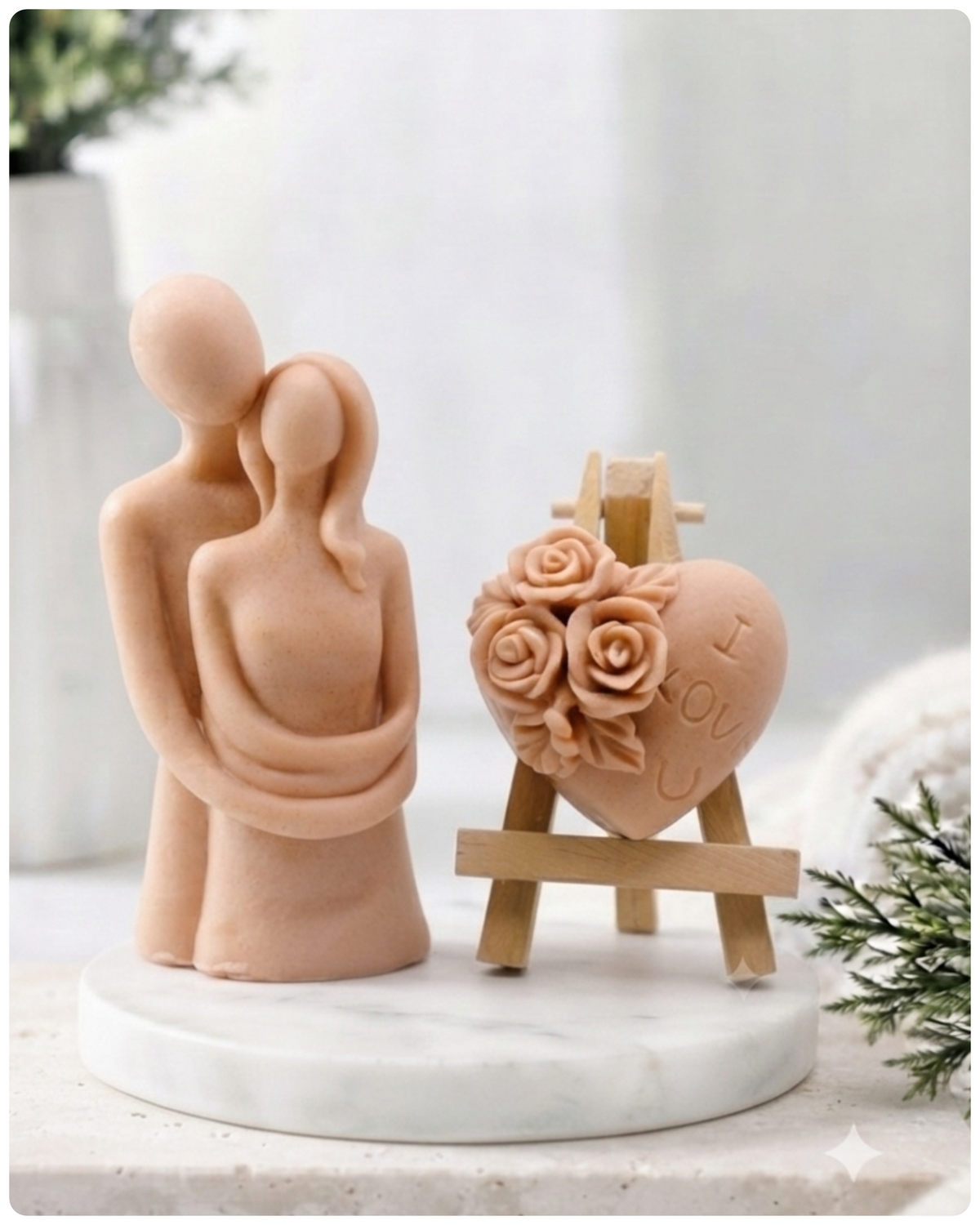This gift set features a stunning soap sculpture of a man gently embracing a woman alongside a charming rose-adorned heart soap, stamped with the heartfelt message "I LOVE U".