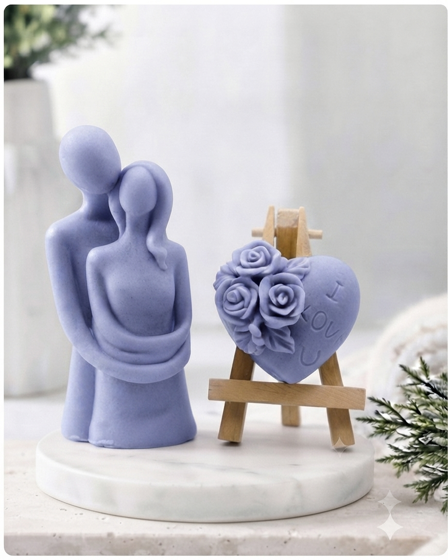 This gift set features a stunning soap sculpture of a man gently embracing a woman alongside a charming rose-adorned heart soap, stamped with the heartfelt message "I LOVE U".